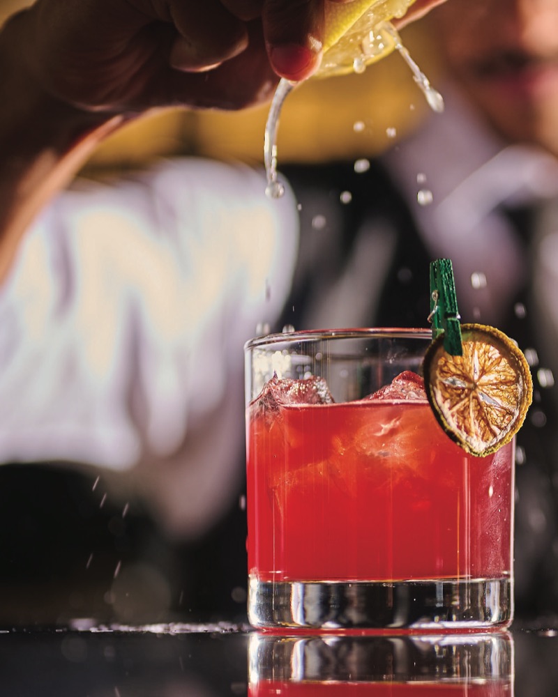 Citrus squeezed over a deep red drink